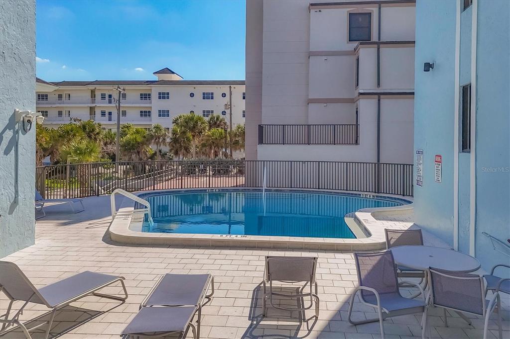 2810 North Beach Road, Unit D205 Englewood, FL 34223 - Photo 37 of 48 a view of a chairs and table in the patio