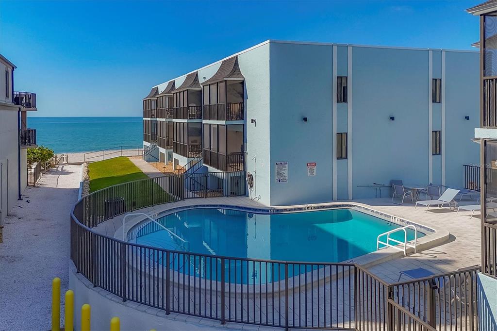2810 North Beach Road, Unit D205 Englewood, FL 34223 - Photo 38 of 48 a view of a balcony with chair and table