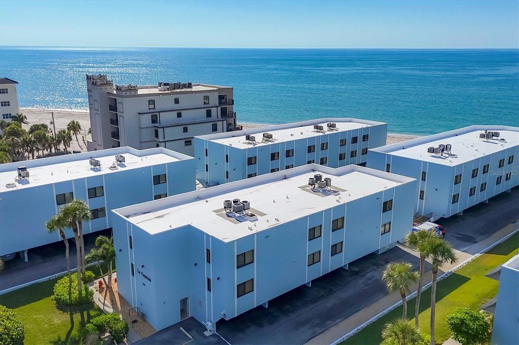 2810 North Beach Road, Unit D205 Englewood, FL 34223 - Photo 4 of 48 a utility room with stainless steel appliances stove a sink dishwasher and cabinets with wooden floor