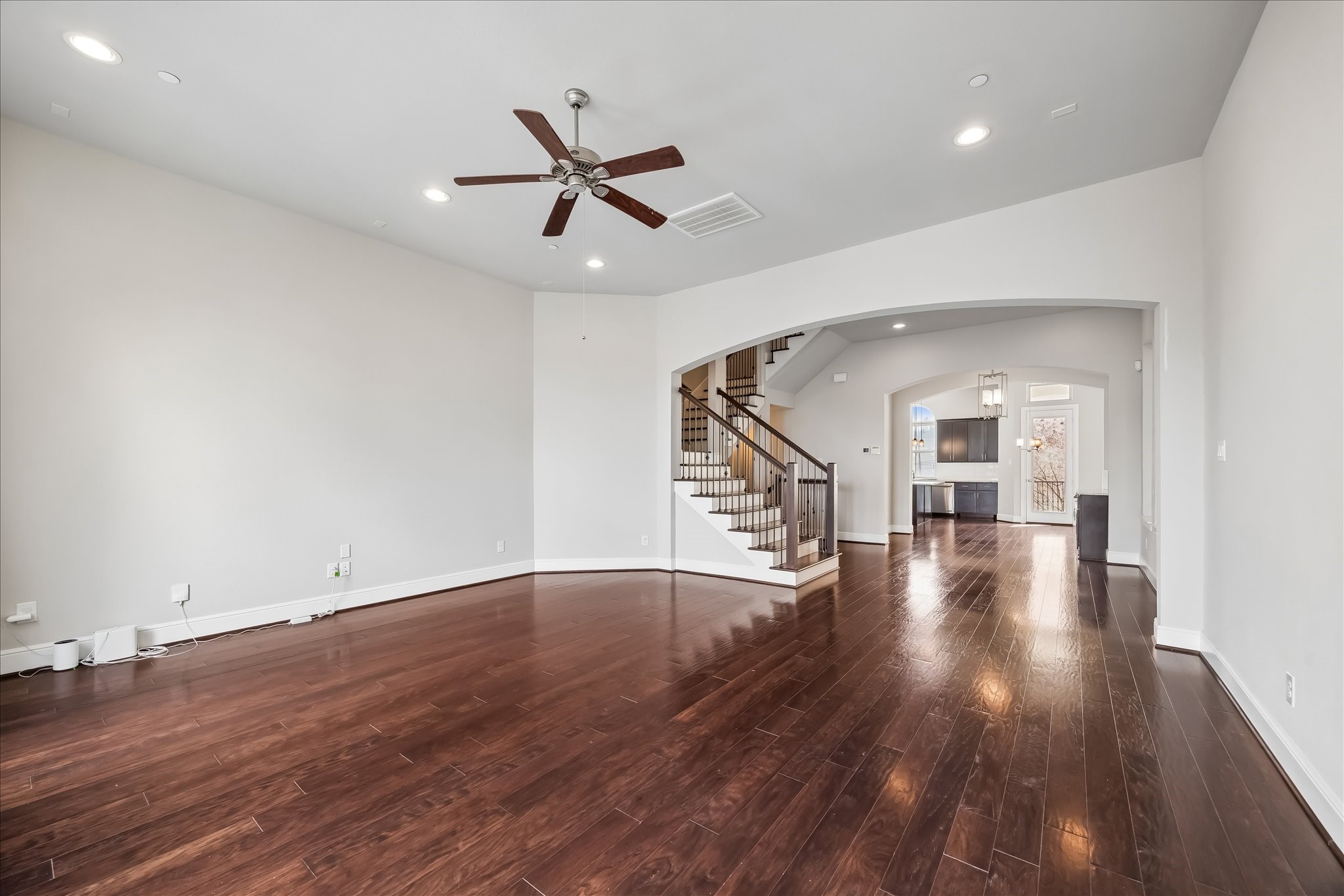 4016 Barnes Street Houston, TX 77007 - Photo 20 of 37 a view of a room with wooden floor staircase and a ceiling fan