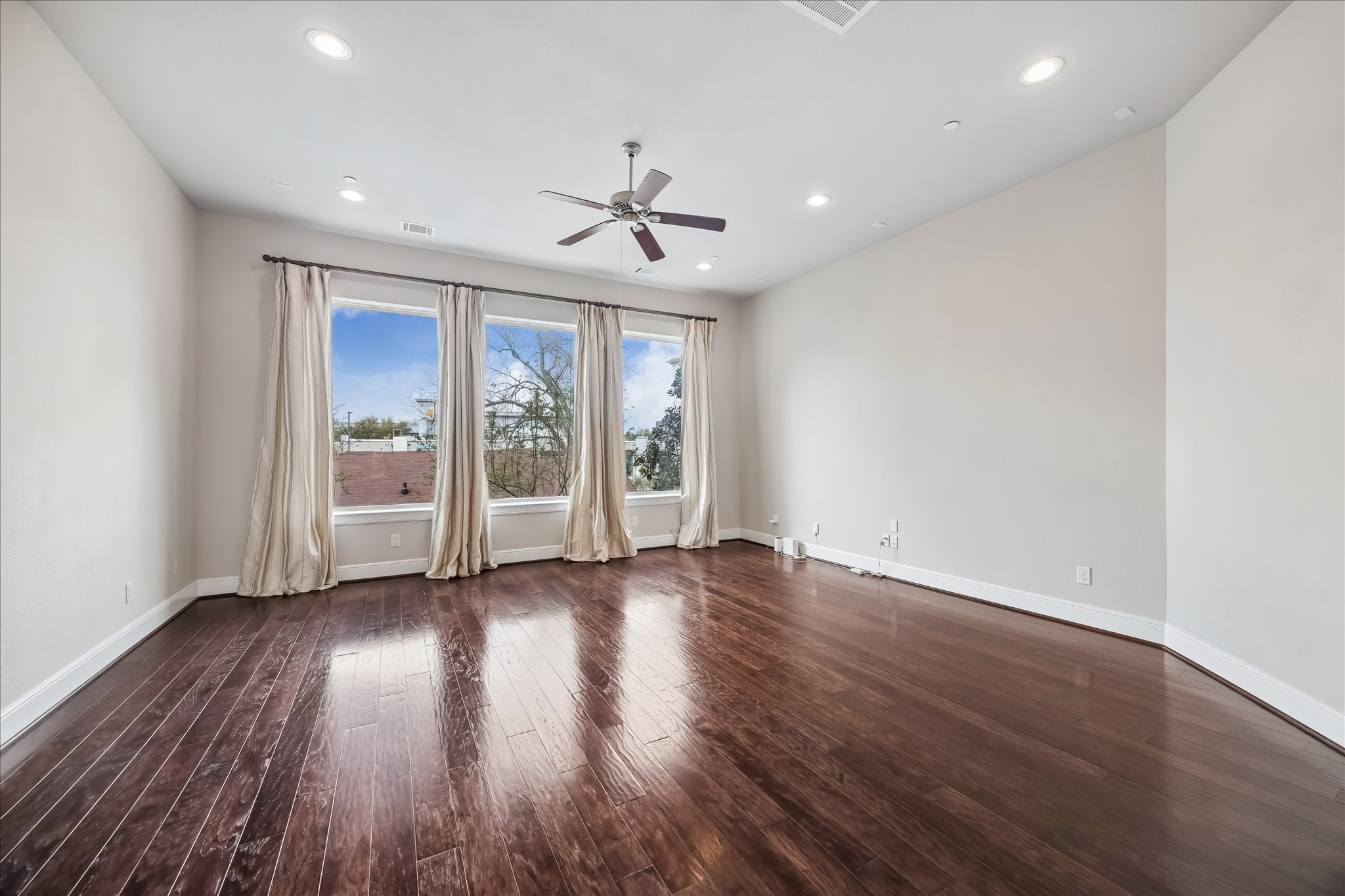4016 Barnes Street Houston, TX 77007 - Photo 21 of 37 a view of an empty room with a window and wooden floor