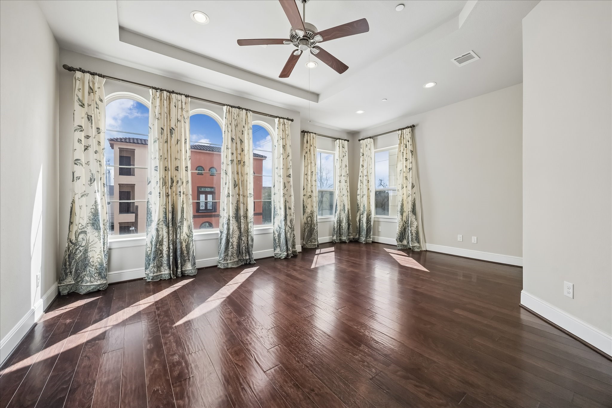 4016 Barnes Street Houston, TX 77007 - Photo 24 of 37 a view of a livingroom with wooden floor and a ceiling fan