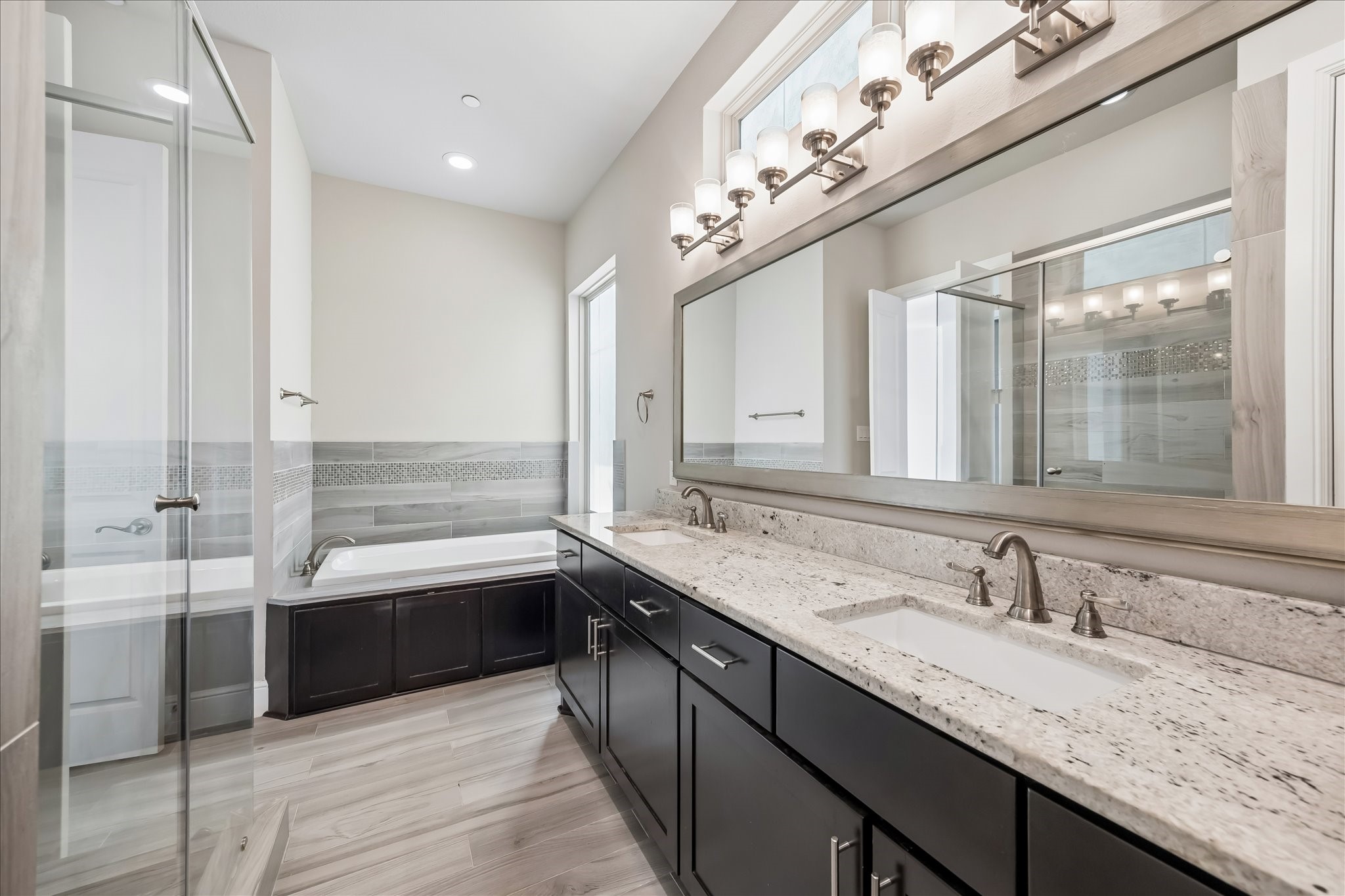 4016 Barnes Street Houston, TX 77007 - Photo 25 of 37 a bathroom with a granite countertop sink mirror and a bathtub