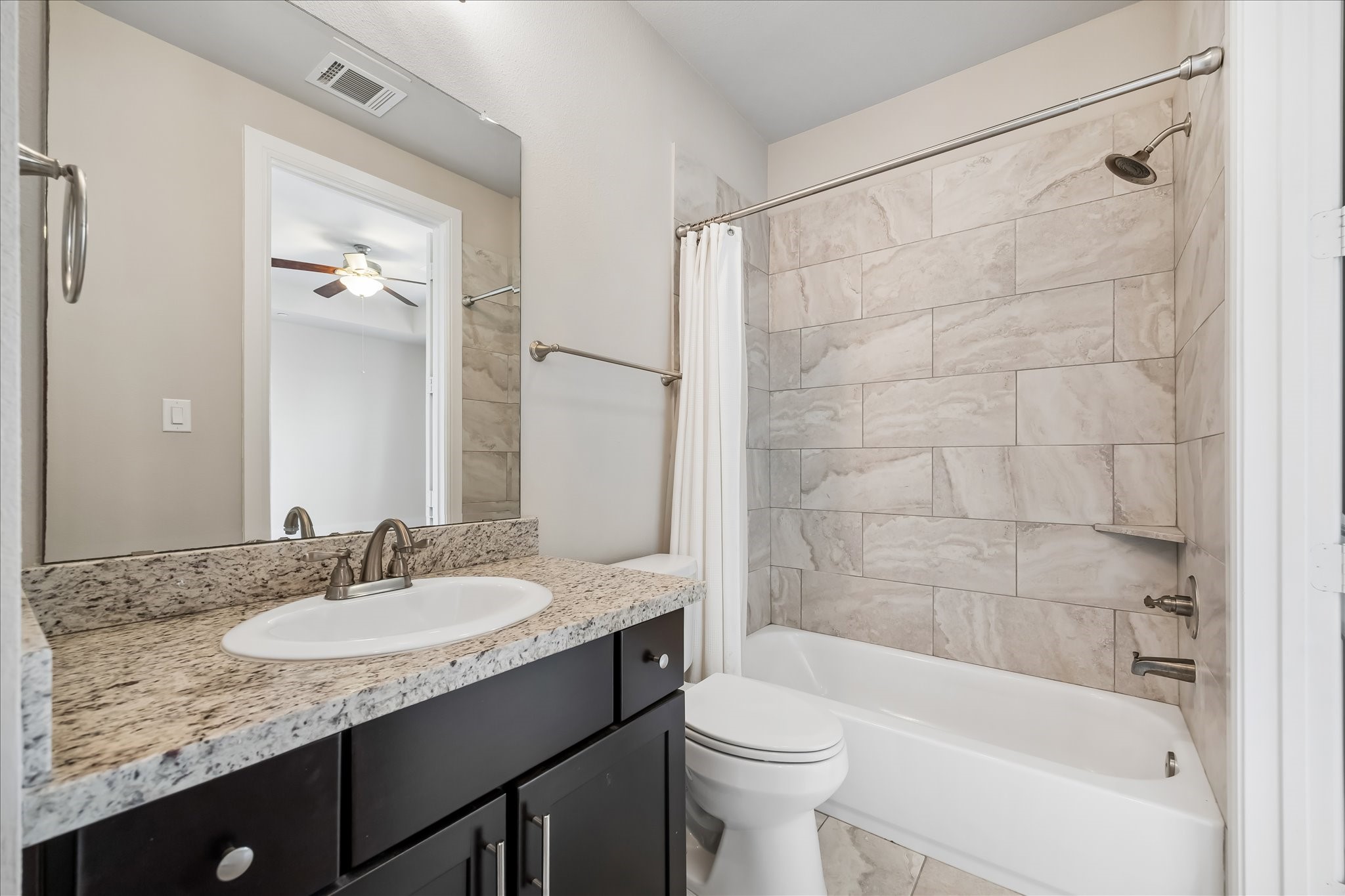 4016 Barnes Street Houston, TX 77007 - Photo 36 of 37 a bathroom with a granite countertop sink toilet and shower