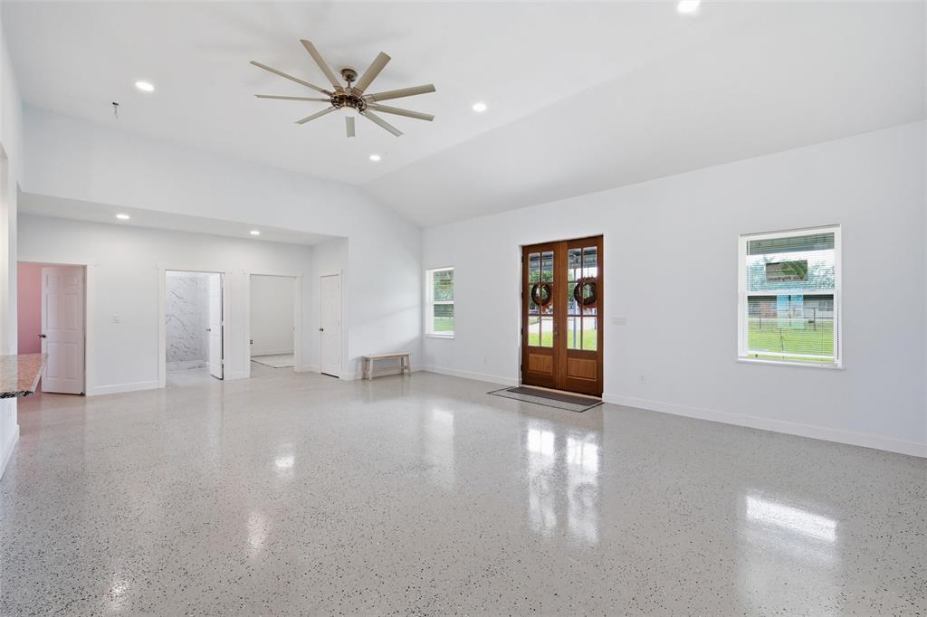 151 Kasberg Road Leroy, TX 76691 - Photo 4 of 40 a view of an empty room with a window and a kitchen