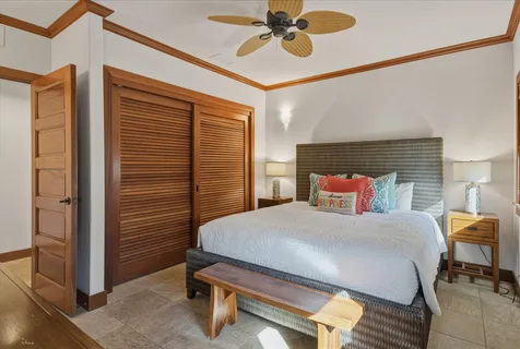 a spacious bedroom with two beds and painting on the wall