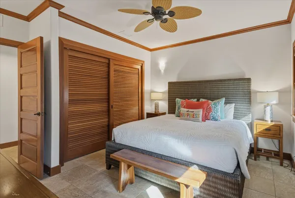 a spacious bedroom with two beds and painting on the wall