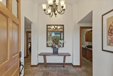 a kitchen with stainless steel appliances granite countertop a stove a sink a oven a dining table and chairs