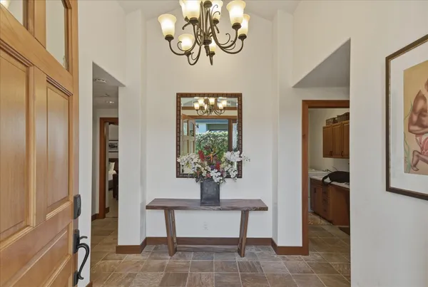 a kitchen with stainless steel appliances granite countertop a stove a sink a oven a dining table and chairs