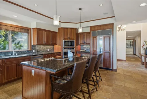 a view of a patio with dining table and chairs