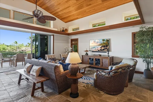 a living room with furniture a chandelier and a table