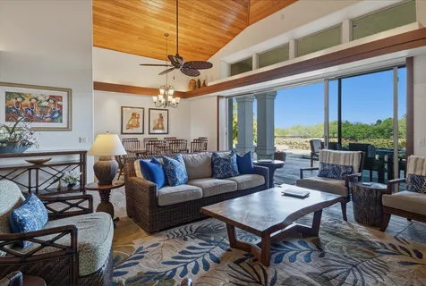 a view of a dining room with furniture and chandelier