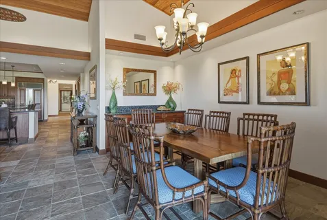 a view of a dining room with furniture and a chandelier
