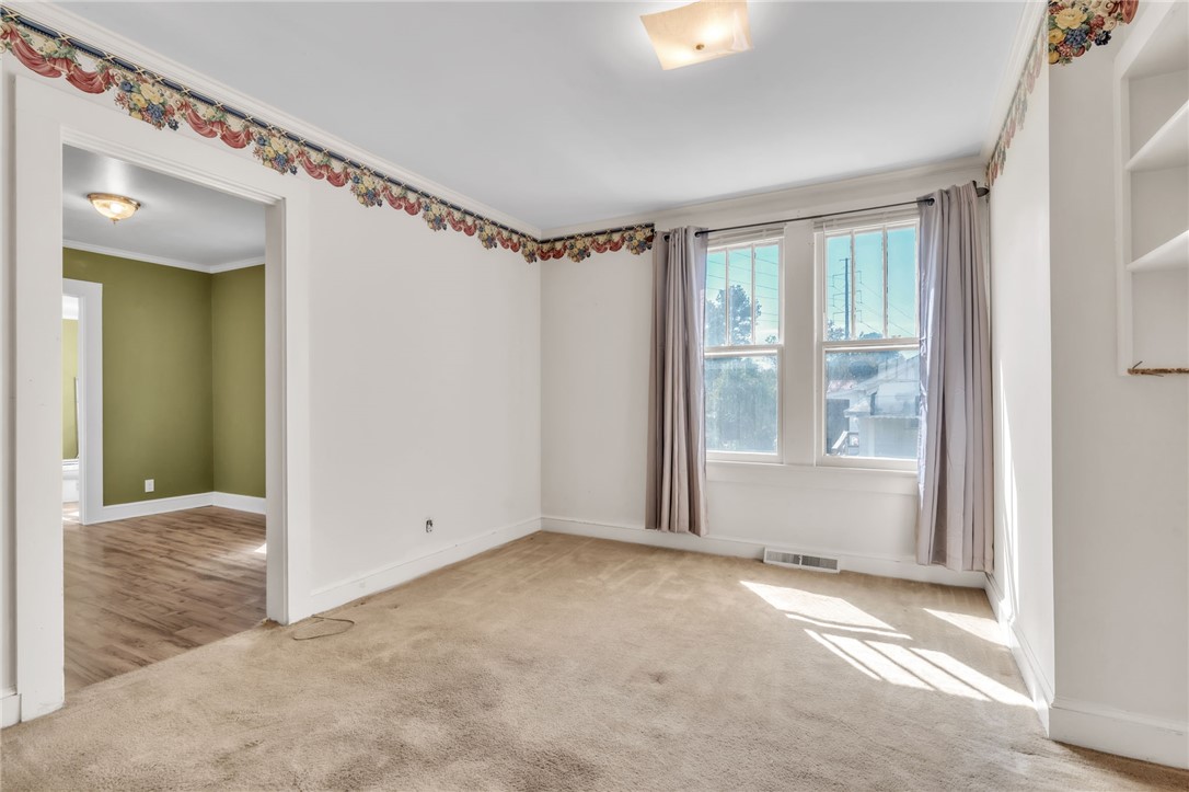 121 Ellison Street Belton, SC 29627 - Photo 21 of 30 This bright room features a warm carpet and ample natural light, with convenient access to an adjacent space.