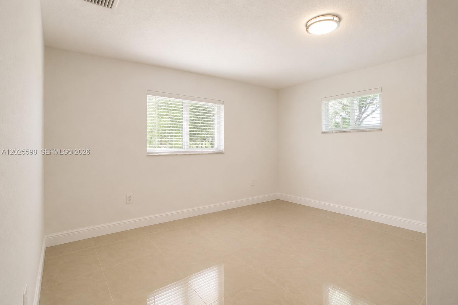 9421 Southwest 150th Street Miami, FL 33176 - Photo 17 of 31 an empty room with a window