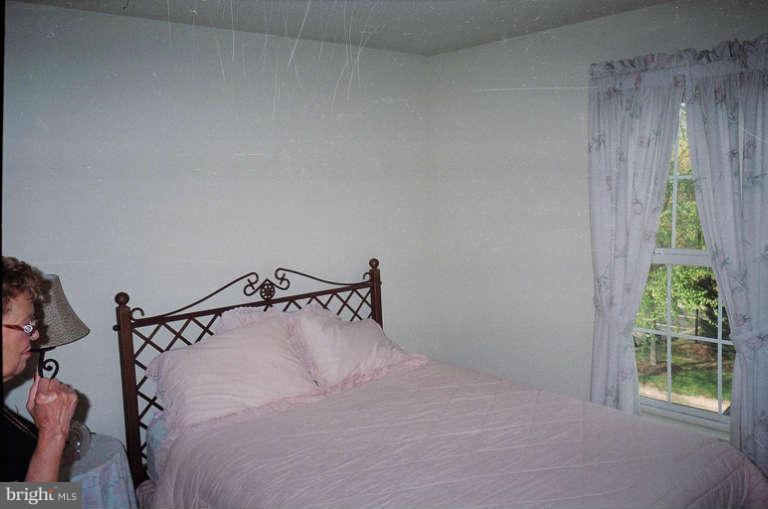 8 Chippewa Court Silver Spring, MD 20906 - Photo 4 of 30 a bedroom with a bed and a window
