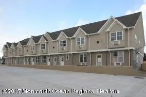 a view of houses with a small yard