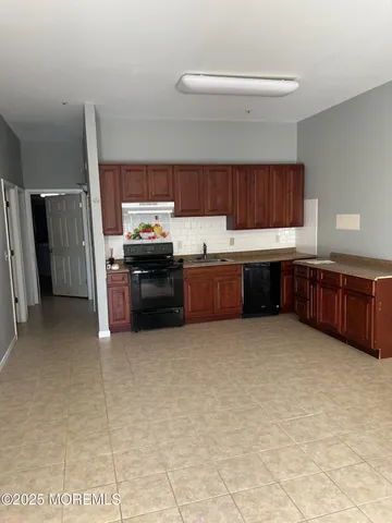 a kitchen with stainless steel appliances granite countertop a sink and cabinets