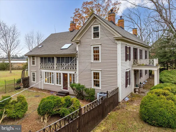 a front view of a house with a yard and potted plants