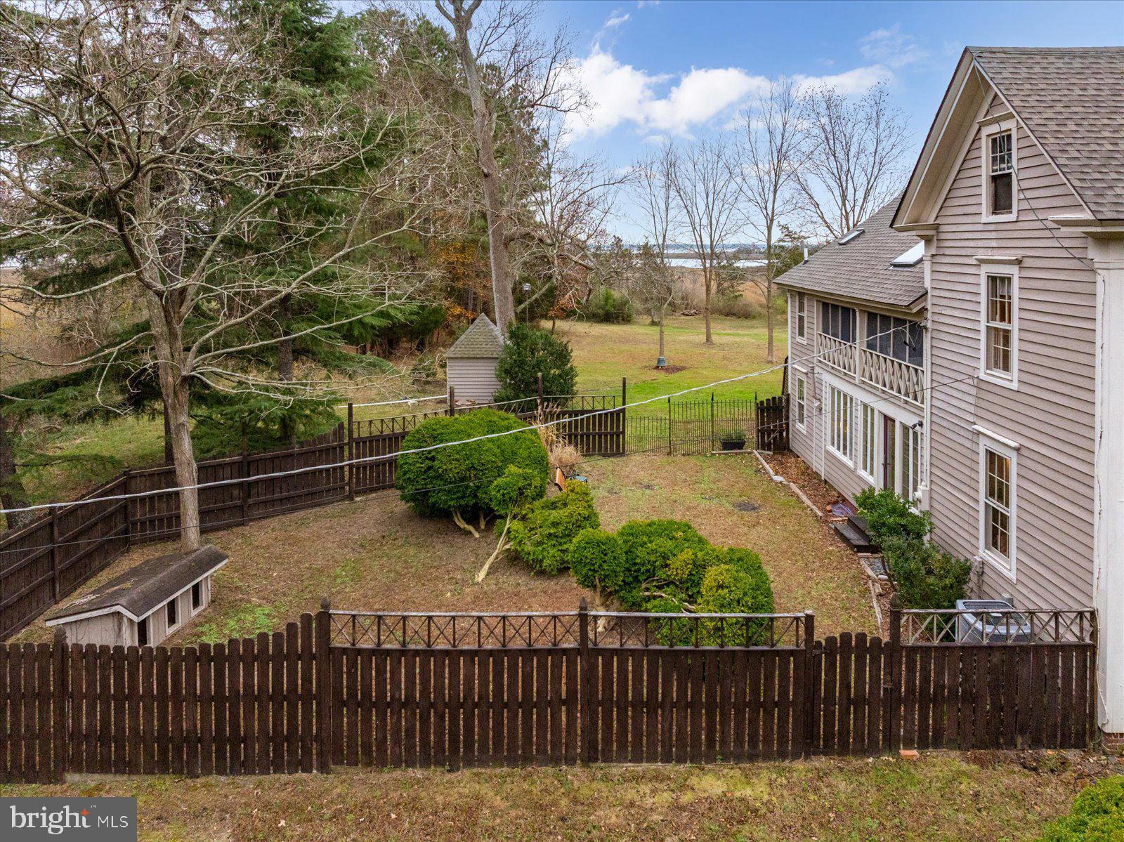 27947 Fairmount Road Westover, MD 21871 - Photo 21 of 122 a view of a brick house with a small yard and wooden fence