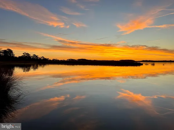 a bedroom with two beds and painting on the wall