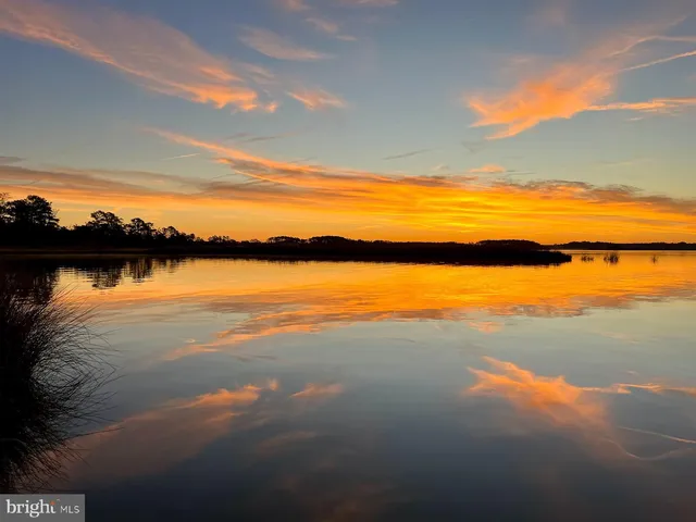 a bedroom with two beds and painting on the wall