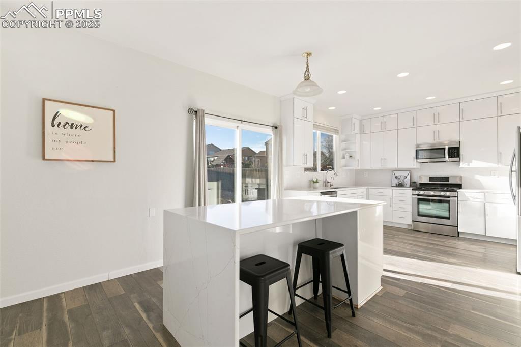 9202 Ballybunion Road Peyton, CO 80831 - Photo 17 of 36 a view of kitchen with center island and stainless steel appliances