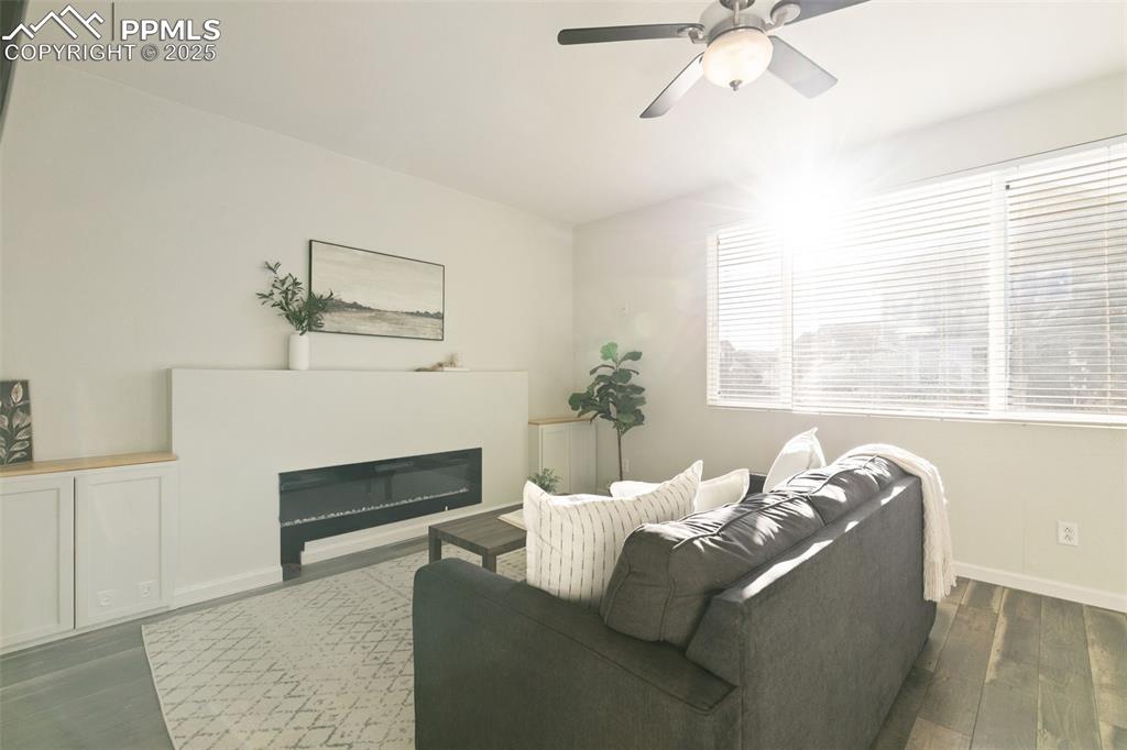 9202 Ballybunion Road Peyton, CO 80831 - Photo 18 of 36 a living room with furniture and a fireplace
