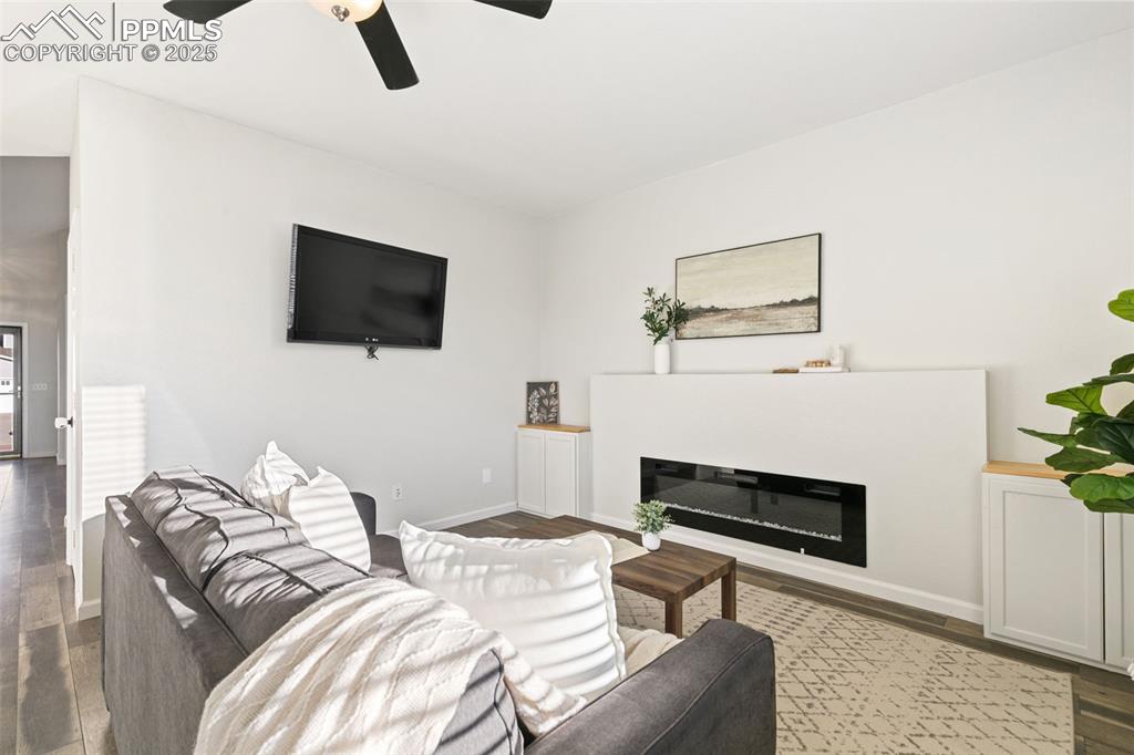 9202 Ballybunion Road Peyton, CO 80831 - Photo 21 of 36 a living room with furniture and a flat screen tv