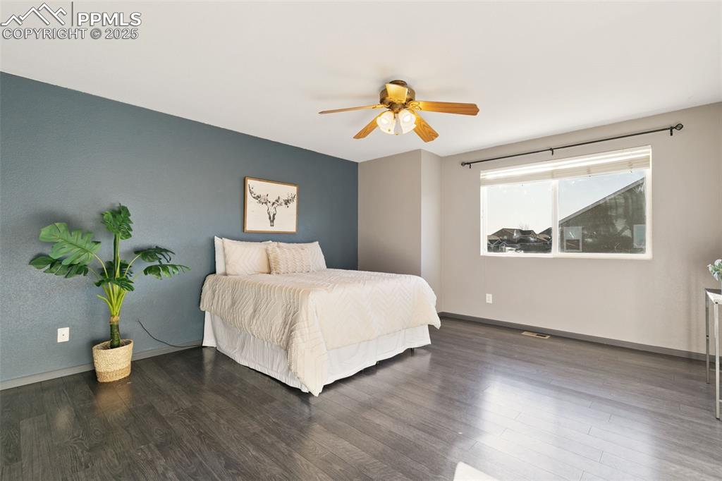 9202 Ballybunion Road Peyton, CO 80831 - Photo 24 of 36 a bedroom with a bed and a potted plant