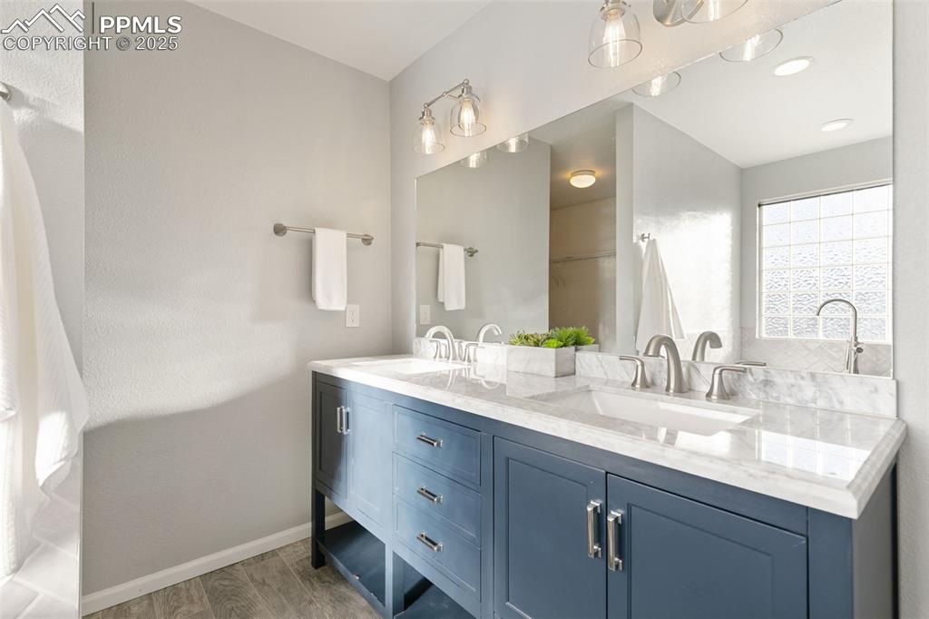 9202 Ballybunion Road Peyton, CO 80831 - Photo 28 of 36 a bathroom with a double vanity sink and a mirror