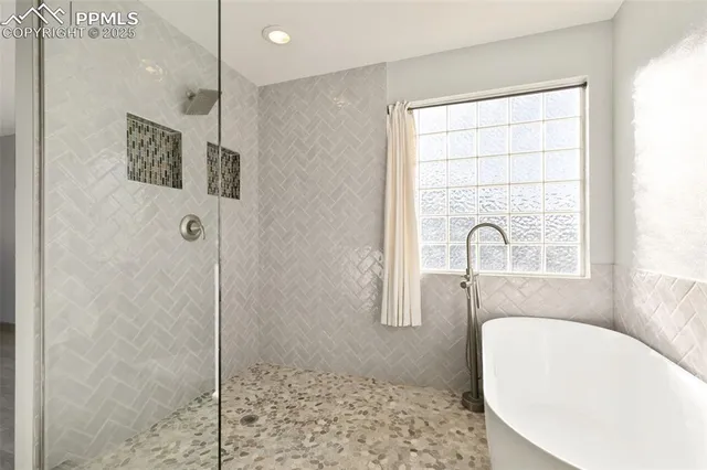 a bathroom with a bathtub and shower