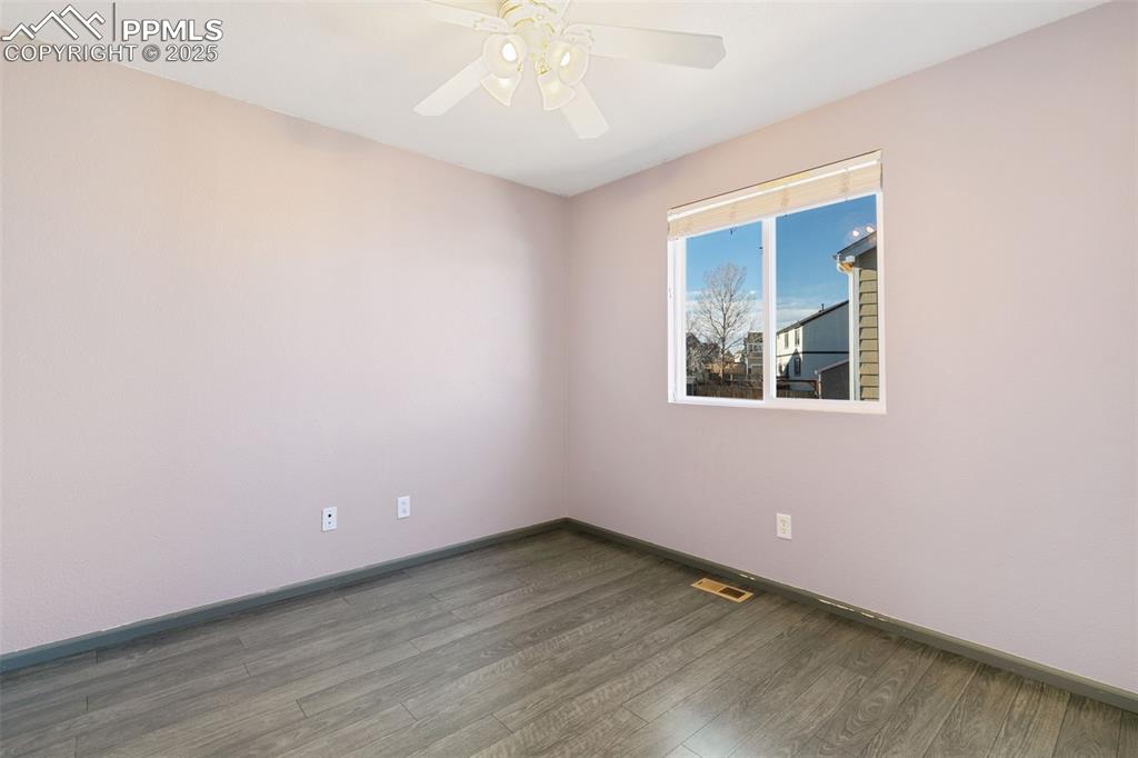 9202 Ballybunion Road Peyton, CO 80831 - Photo 30 of 36 an empty room with wooden floor and windows