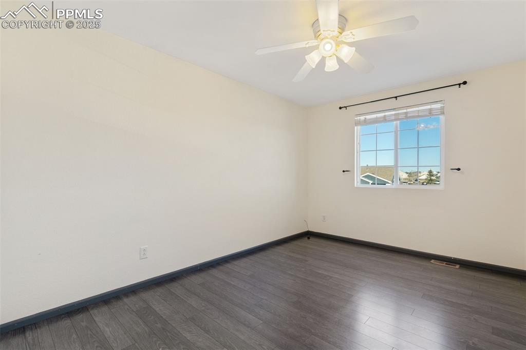 9202 Ballybunion Road Peyton, CO 80831 - Photo 33 of 36 an empty room with wooden floor and a ceiling fan