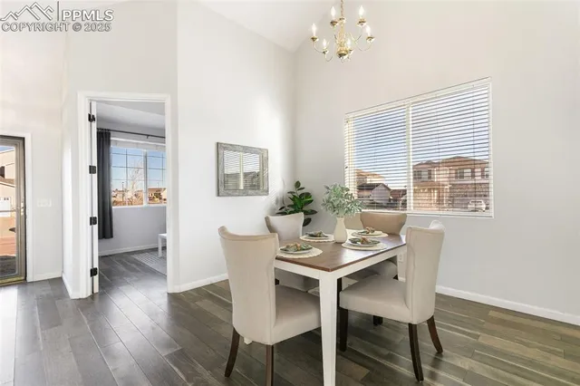 a dining room with furniture window and wooden floor