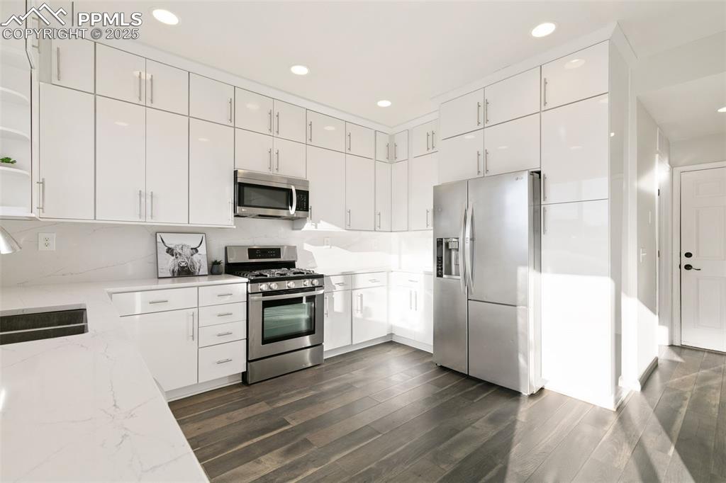 9202 Ballybunion Road Peyton, CO 80831 - Photo 9 of 36 a kitchen with a refrigerator stove and microwave