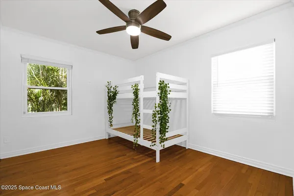a view of empty room with wooden floor