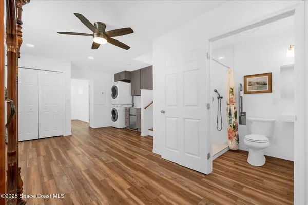 a kitchen with a sink and wooden floors
