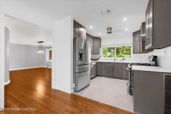 a kitchen with stainless steel appliances a refrigerator and a stove top oven