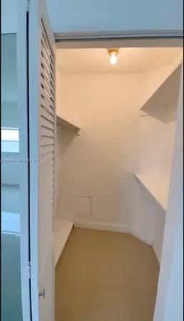a kitchen with granite countertop white cabinets and black appliances
