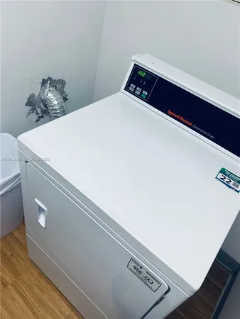 a lobby with a potted plant and a chandelier