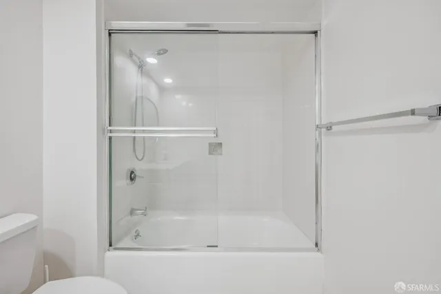 a bathroom with a glass shower door