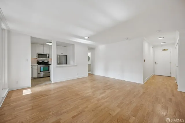 a view of an empty room with kitchen