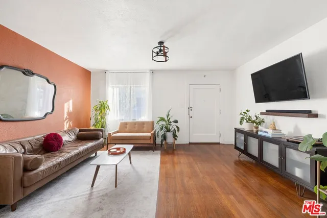 a view of a livingroom with furniture and a mirror