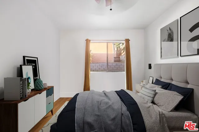 a bedroom with a bed and wooden floor