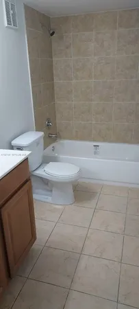 a bathroom with a sink a toilet and bathtub