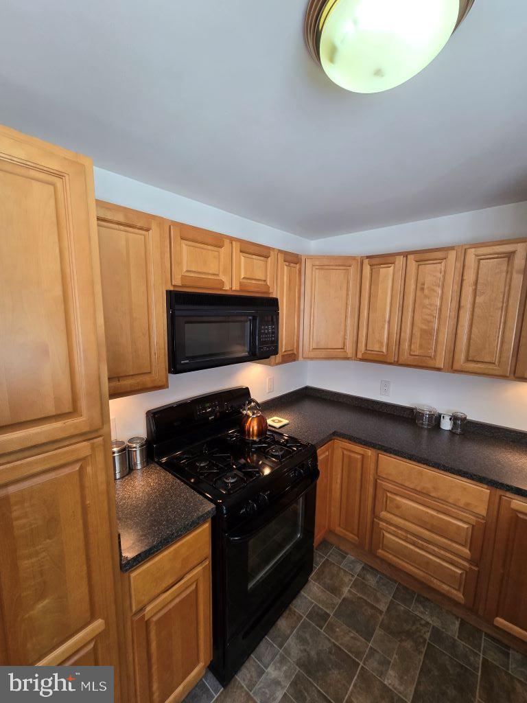 164 Edison Road Cherry Hill, NJ 08034 - Photo 10 of 27 a kitchen with stainless steel appliances granite countertop a stove a sink and a microwave
