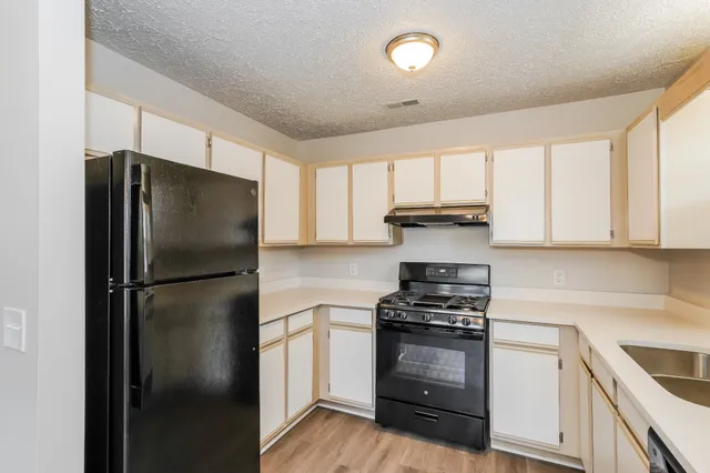 a kitchen with a refrigerator stove and microwave