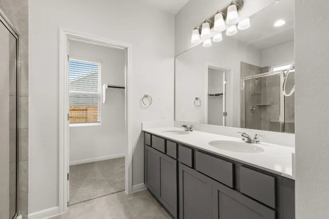 a bathroom with a glass shower door