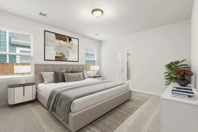 a spacious bedroom with a bed and a window